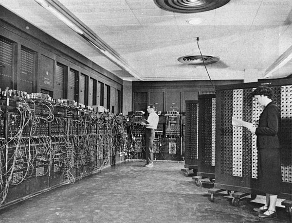 Man and woman working on the ENIAC computer.