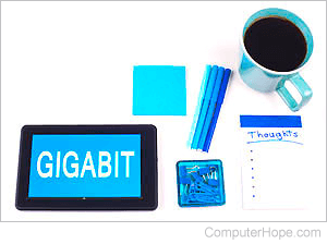 Tablet with the word Gigabit on the screen, and a cup of coffee.