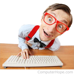 Computer geek with red glasses on keyboard.