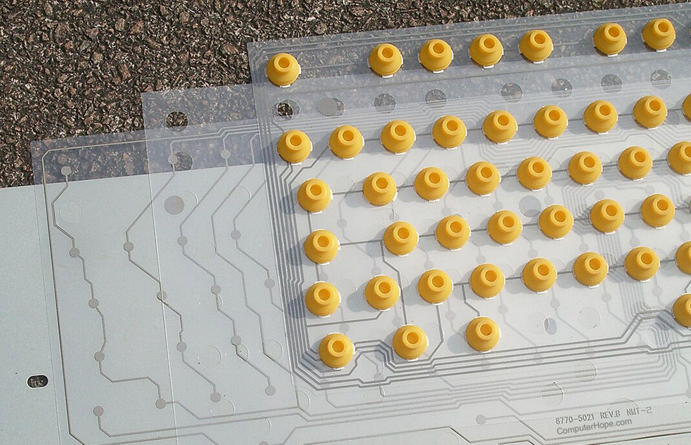 Computer membrane keyboard assembly showing each of the layers that make up a membrane keyboard.